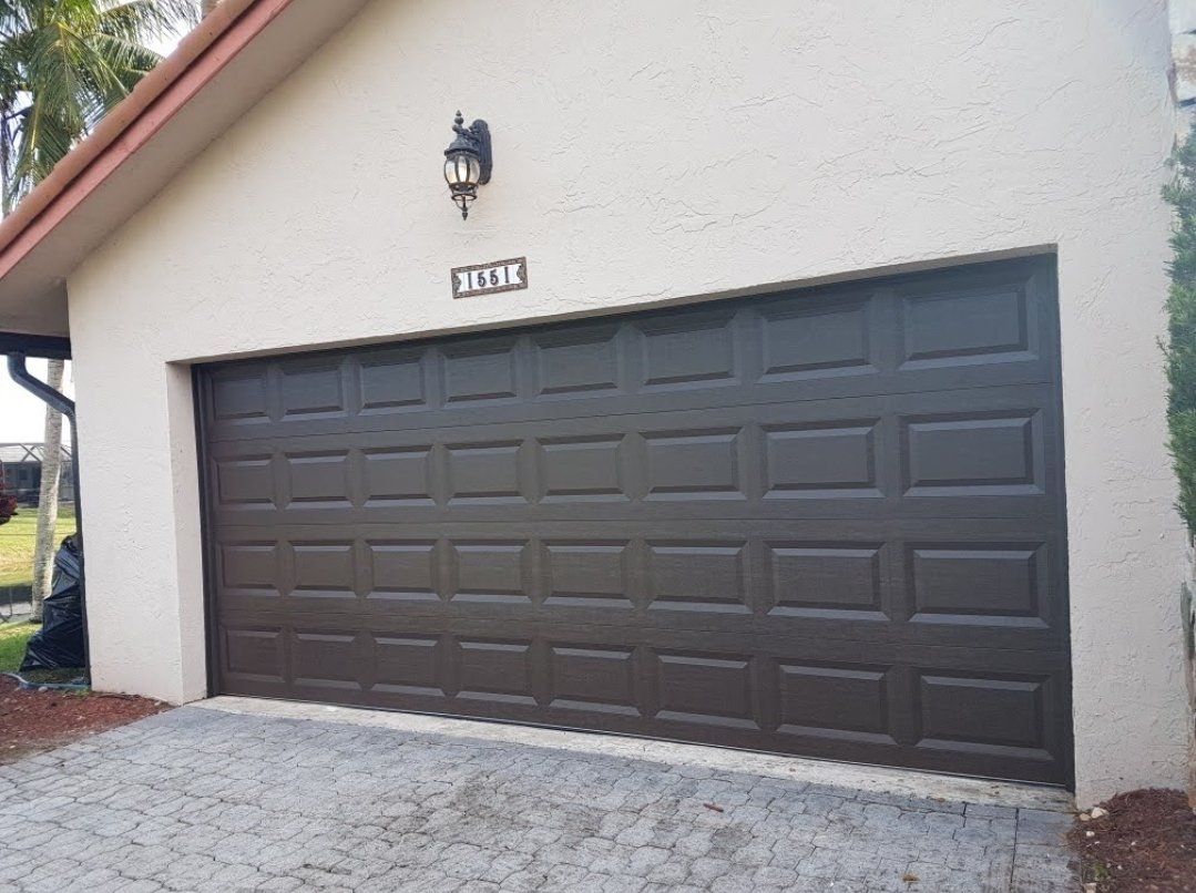 Dark bronze garage door installed on a Florida home
