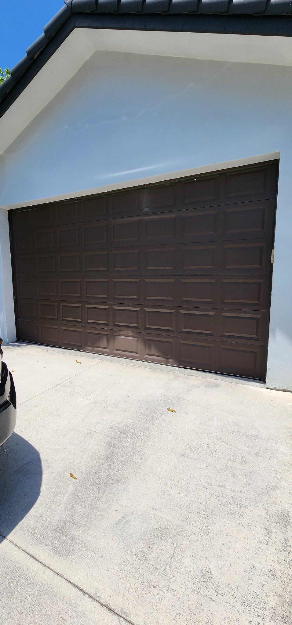 Dark brown paneled garage door on a South Florida home