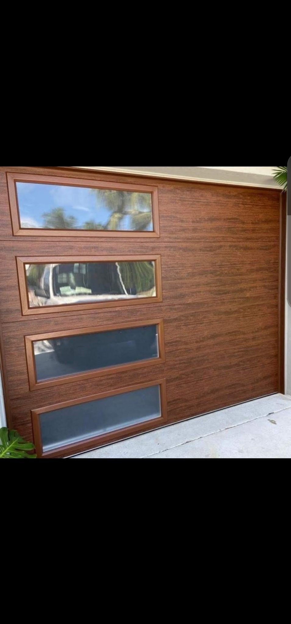 Wood-look garage door with windows installed in South Florida